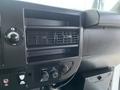 Dashboard of a 2017 Chevrolet Express showing air conditioning vents control knobs and a compartment below