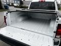 A 2022 RAM 1500 Classic with an open truck bed showing a white, clean interior surface and a bed liner
