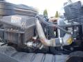 Engine compartment of a 2014 International Durastar showing various components including the air filter and piping system