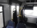 Interior of a 2016 Chevrolet Express with blue seats and yellow handrails mounted on the walls