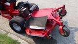 A red 2014 Ferris Mower ISX 800 with a large cutting deck and rear wheels visible showcasing its design and functionality