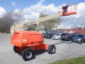 A 2008 JLG Boom Lift with a telescoping arm extended and a platform at the end, designed for elevating workers to high areas