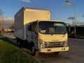 A 2017 Isuzu NPR truck with a white box cargo area parked on a street