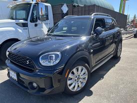 A black 2022 Mini Countryman with a sleek design and distinctive front grille parked in a lot