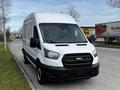 A white 2020 Ford Transit van with a high roof and no side windows parked on the street