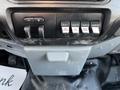 Dashboard controls for a 2011 Ford F-450 SD featuring switches for auxiliary functions and a central compartment