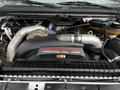 Close-up of the engine compartment of a 2007 Ford F-550 featuring a Power Stroke V8 Turbo Diesel engine with visible turbocharger and various components