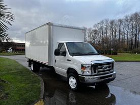 A white 2019 Ford Econoline box truck with a large cargo area and front grille is parked with its wheels on a paved surface