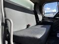 A gray two-person bench seat inside a 2016 Freightliner M2 106 truck with seat belts visible