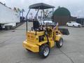 A yellow 2024 AGT KRW 23 Mini loader with a small front bucket and a cab featuring a black seat and controls