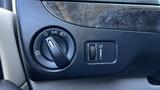 A control panel featuring a light switch dial and a button with an icon for interior lights in a 2016 Dodge Grand Caravan