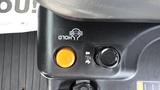 Close-up view of control panel buttons on a 2018 Kubota RTV X1100c featuring an orange hold button and a pull lever with operational symbols