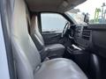 Interior view of a 2009 GMC Savana showing two front seats and the dashboard with controls and a center console