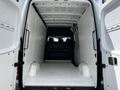 Interior view of a 2012 Mercedes-Benz Sprinter van showing a spacious cargo area with a flat floor and raw paneling on the walls