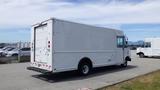 A white 2011 Ford Econoline box truck with no visible markings parked in a lot viewed from the rear right side