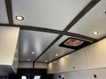 A 2017 Ford Transit van interior featuring a ceiling with wood accents recessed lighting and a vent fan