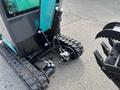 A 2024 AGT Industrial Green QH13R Mini Excavator featuring a compact design and rubber tracks with hydraulic components visible near the base