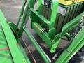 A green 2003 John Deere 790 tractor with a prominent front grill and various hydraulic lines attached to the frame