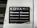 A 2009 Ford Econoline with a Kova Red Utl Engineering label displaying the make model serial number and inspection dates
