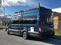 A blue 2017 Ford Transit van with a high roof and black ladder on the rear side