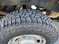 Close-up of a heavily treaded tire on a 2013 Ford F-250 SD showing detailed patterns and texture on the rubber surface