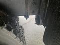 A close-up view of the wheel and axle of a 2016 International 7400 truck showing details of the tire tread and undercarriage components