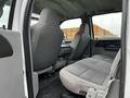 Interior view of a 2007 Ford F-550 showing front seats and rear bench seat with gray fabric upholstery