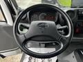 A close-up view of the steering wheel and dashboard of a 2019 Hino 195 showing the speedometer and control panel