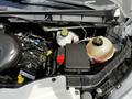 Close-up of the engine compartment of a 2018 Ford Transit showcasing various components including the engine block fluid reservoirs and electrical systems
