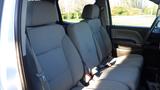 Interior view of a 2016 Chevrolet Silverado 3500HD showing the front seats with a spacious layout and gray upholstery