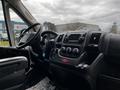 Interior view of a 2021 RAM Promaster featuring a steering wheel dashboard and control panel with audio and climate controls