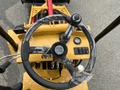 Overview of the steering wheel and controls of a 2024 AGT Industrial KRW23 Mini Loader with plastic wrap on the steering wheel and various buttons and gauges visible