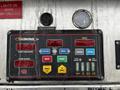 Control panel of a 2009 Spartan Gladiator featuring various buttons and gauges for engine monitoring and pump operations