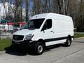 A white 2017 Mercedes-Benz Sprinter van with a high roof and black accents parked on a pavement