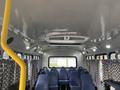 Interior view of a 2012 Chevrolet Express showing blue fabric seats and a ceiling with lighting and air conditioning vents