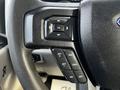 Close-up of the steering wheel controls of a 2017 Ford F-550 featuring buttons for navigation and cruise control