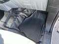 A black rubber floor mat with the word "SUPER DUTY" embossed on it placed in the footwell of a 2013 Ford F-250 SD
