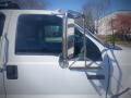 A 2005 Ford F-750 with a shiny chrome side mirror attached to the driver's side door