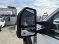 A close-up of the side mirror of a 2023 Ford F-550 showing the reflective surface and its angular design