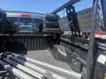 The image shows the interior of a 2010 Toyota Tacoma truck bed with storage compartments and aluminum bars arranged inside