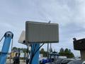 A 2003 U-Built Reel Trailer with a rectangular white box on top connected to blue support beams and wires