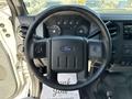 Steering wheel of a 2012 Ford F-450 SD with controls and dashboard gauges visible in the background