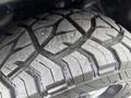 Close-up of a rugged tire tread on a 2018 RAM 1500 showing deep grooves and textured patterns designed for off-road traction