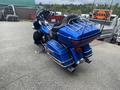 A blue 2017 Harley-Davidson FLHTKL motorcycle parked with a touring saddle and luggage rack on the back