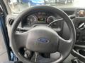 Steering wheel and dashboard of a 2009 Ford Econoline showing gauges and controls without any driver present