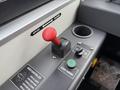 A close-up view of the control panel in a 2018 Grande West Vicinity featuring a red gear shift lever a green engine start button and an odor controller switch