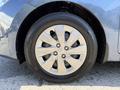 A close-up of a silver alloy wheel with five spokes on a 2018 Kia Rio5 mounted on a black tire with visible tread patterns