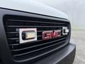 Front grille of a 2016 GMC Savana featuring the GMC logo and integrated lights