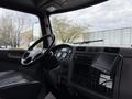 Interior of a 2016 Peterbilt 348 featuring a steering wheel dashboard with gauges and a touchscreen display
