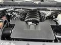 The image shows the engine of a 2018 Chevrolet Silverado 1500 featuring a large black plastic cover over the V8 engine components